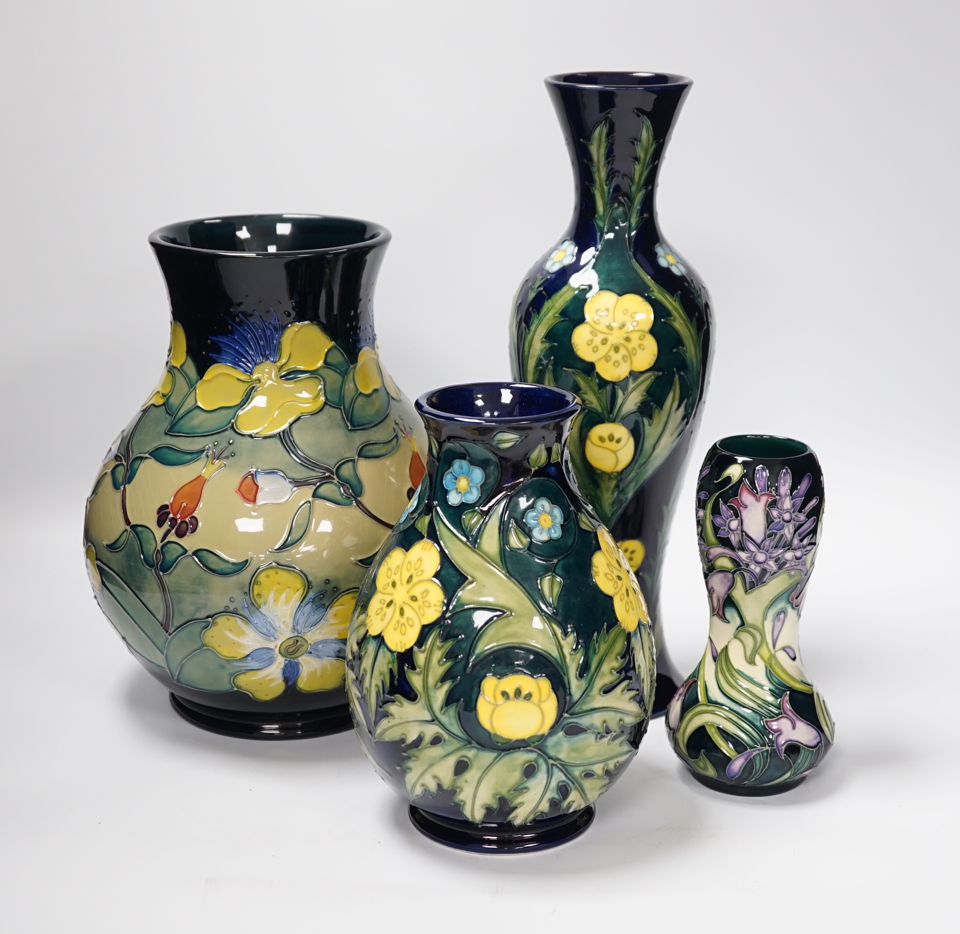 Two Moorcroft 'buttercup' vases and two other Moorcroft vases, tallest 31cm (4)